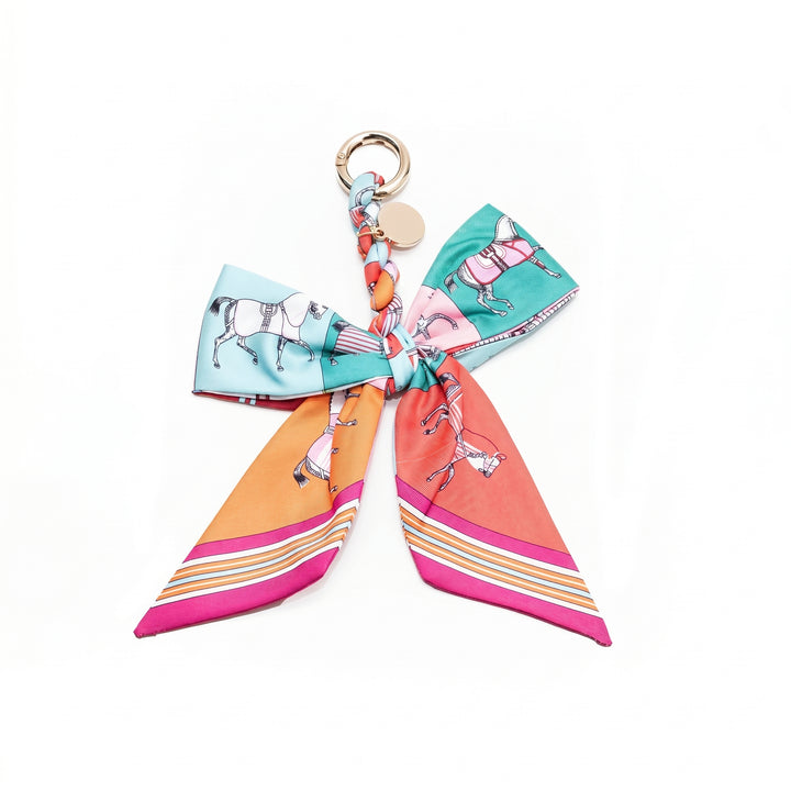 Multicolour horse print fabric bow bag charm on a gold clasp
