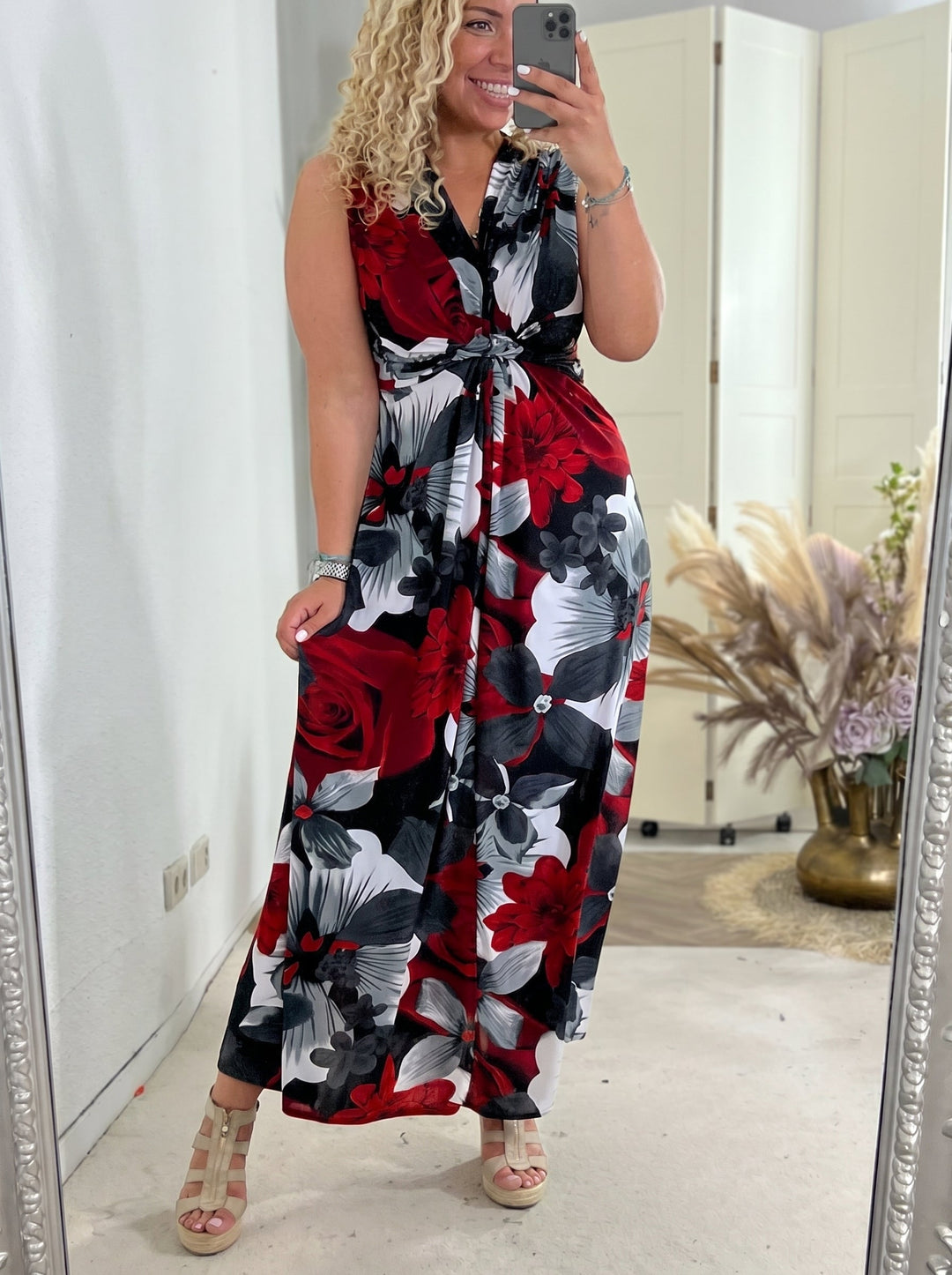 Woman wearing a red floral sleeveless maxi dress