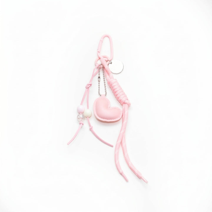 Pink padded heart bag charm with a beaded cord
