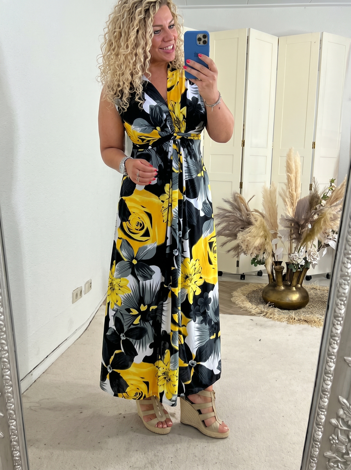 Woman wearing a yellow floral sleeveless maxi dress