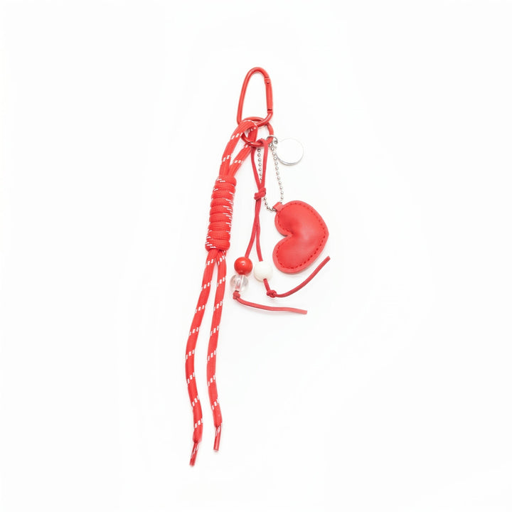 Red padded heart bag charm with a beaded cord