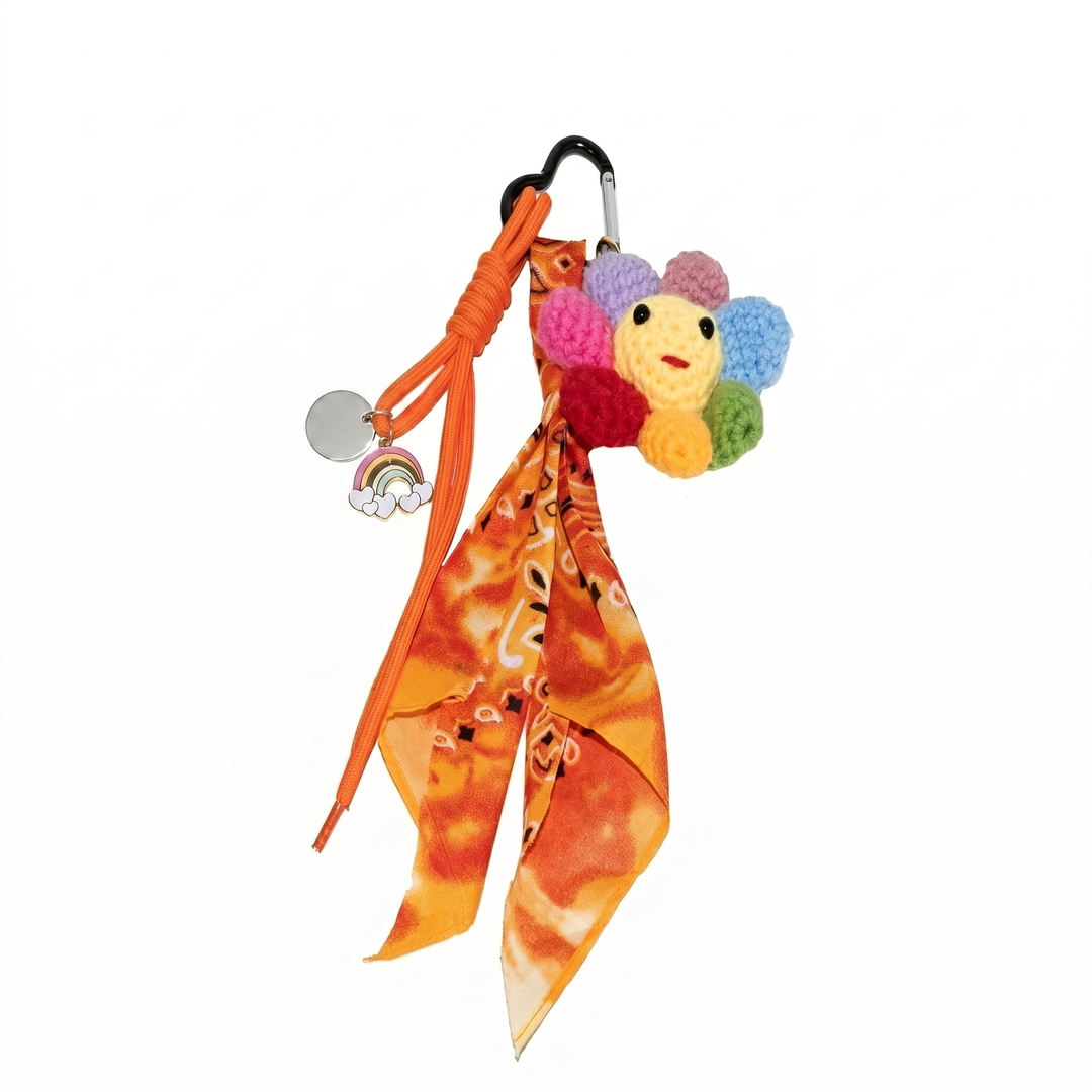 Orange paisley bandana bag charm with a colourful crochet flower and a rainbow charm