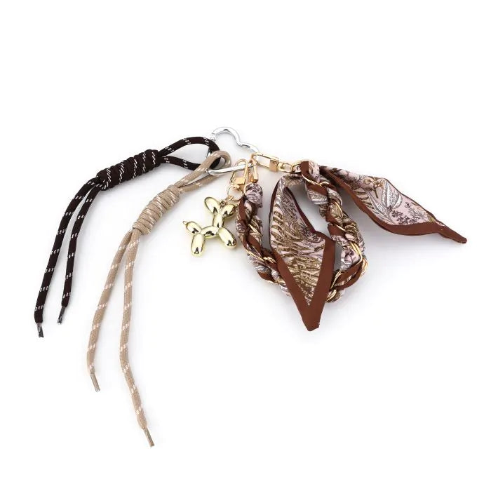 Brown balloon dog charm with braided cords and silky scarf on a clasp keyring