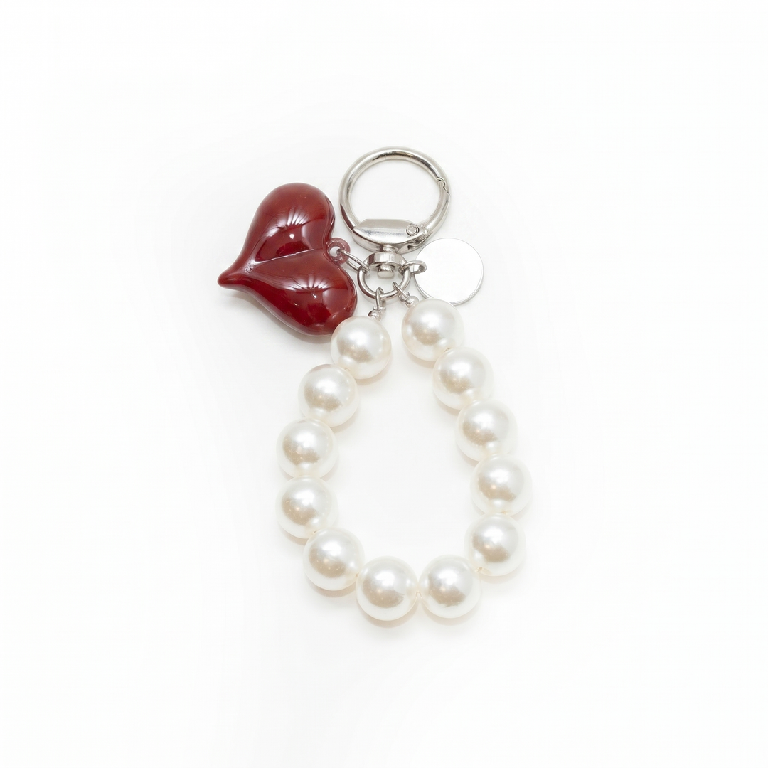 White pearl loop bag charm with a glossy red heart