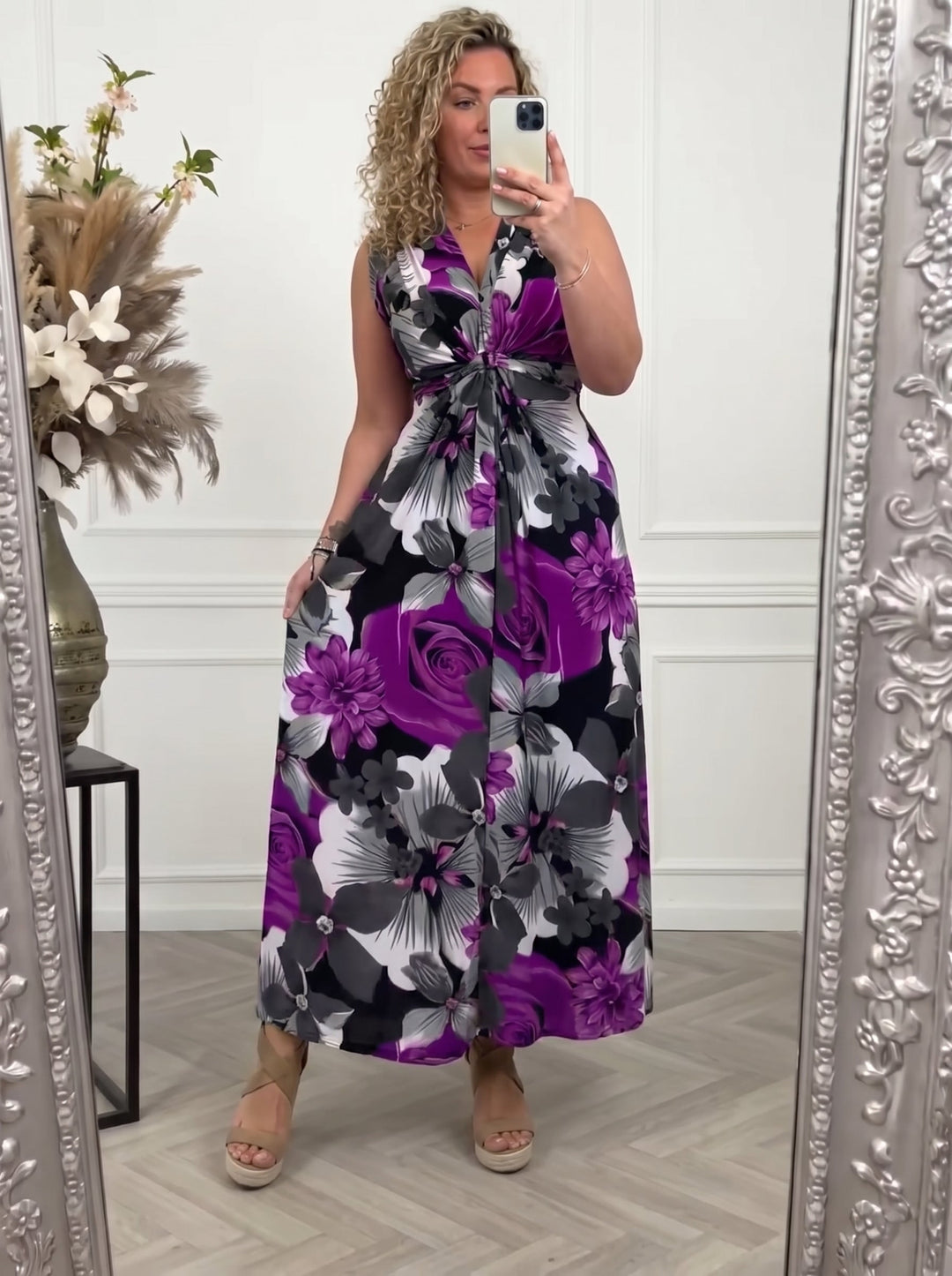 Woman wearing a purple floral sleeveless maxi dress