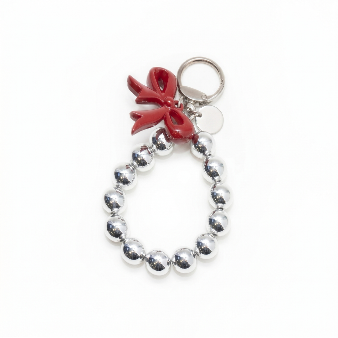 Silver beaded loop bag charm with a glossy red bow