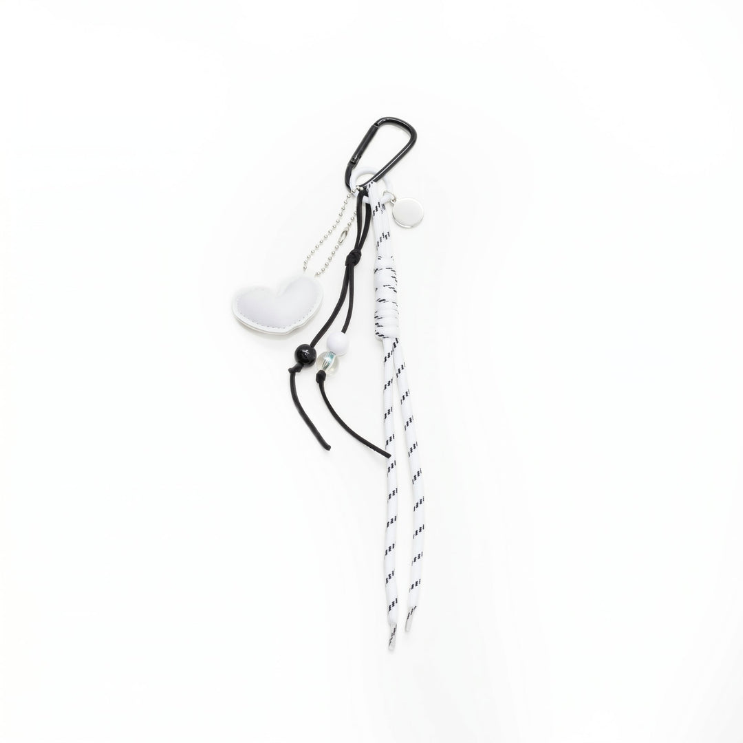 White padded heart bag charm with a beaded cord