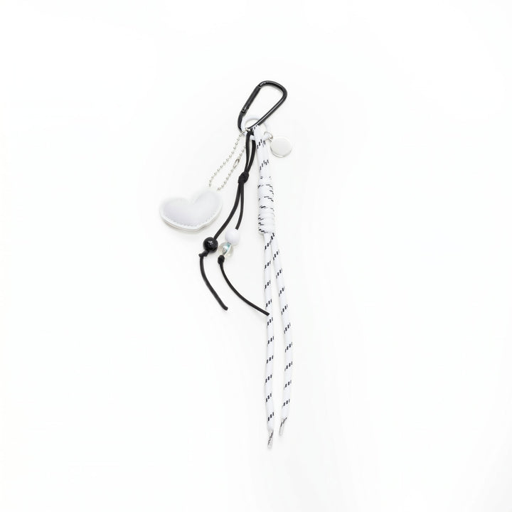 White padded heart bag charm with a beaded cord